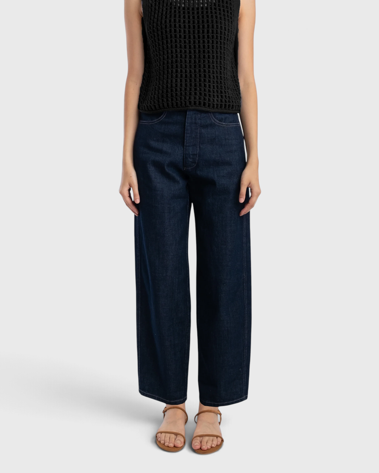 JONES + CO dark indigo high-rise relaxed-fit jeans with outseam piecing and a rounded leg shape on a model.