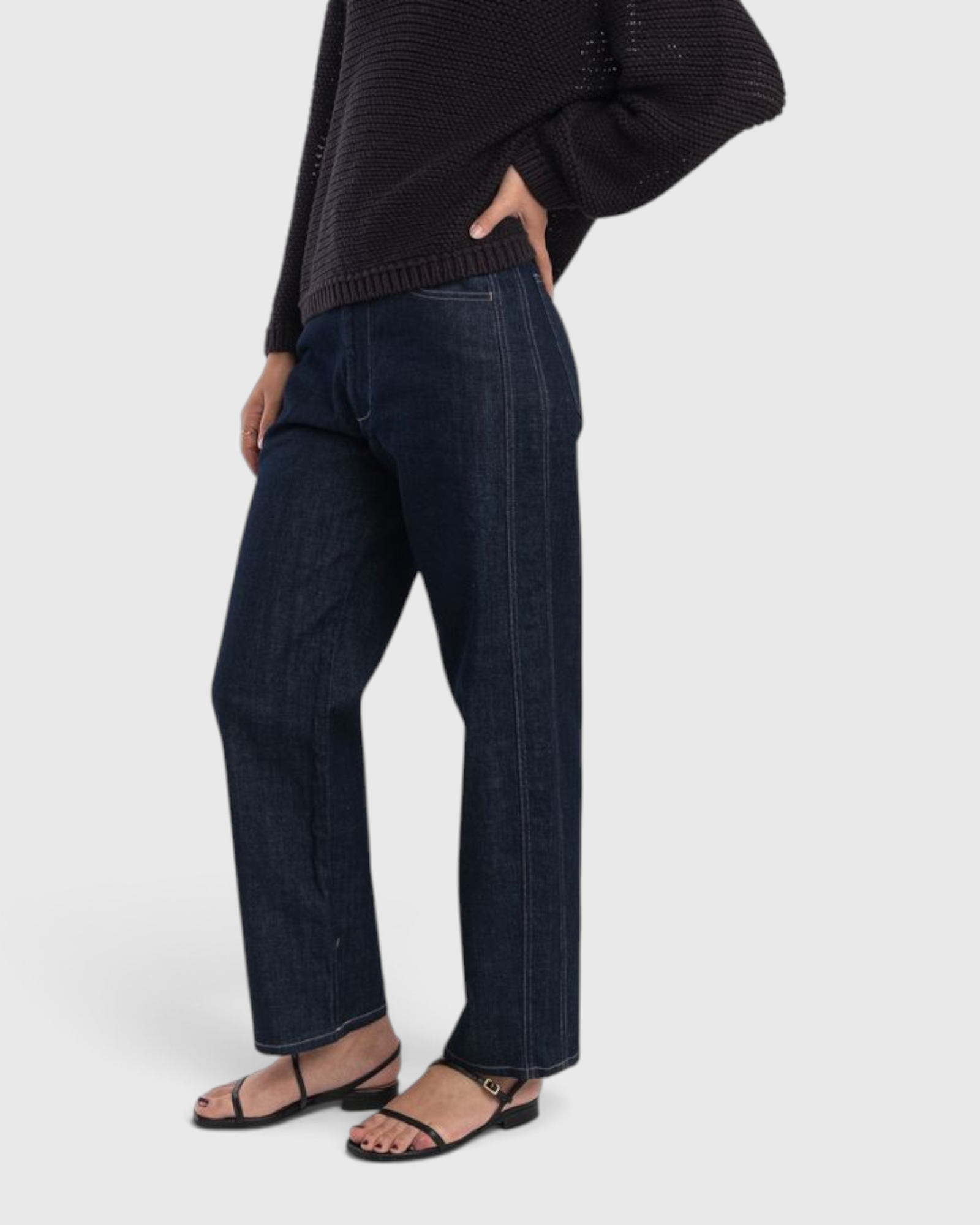 JONES + CO dark indigo high-rise relaxed-fit jeans with outseam piecing and a rounded leg shape on a model