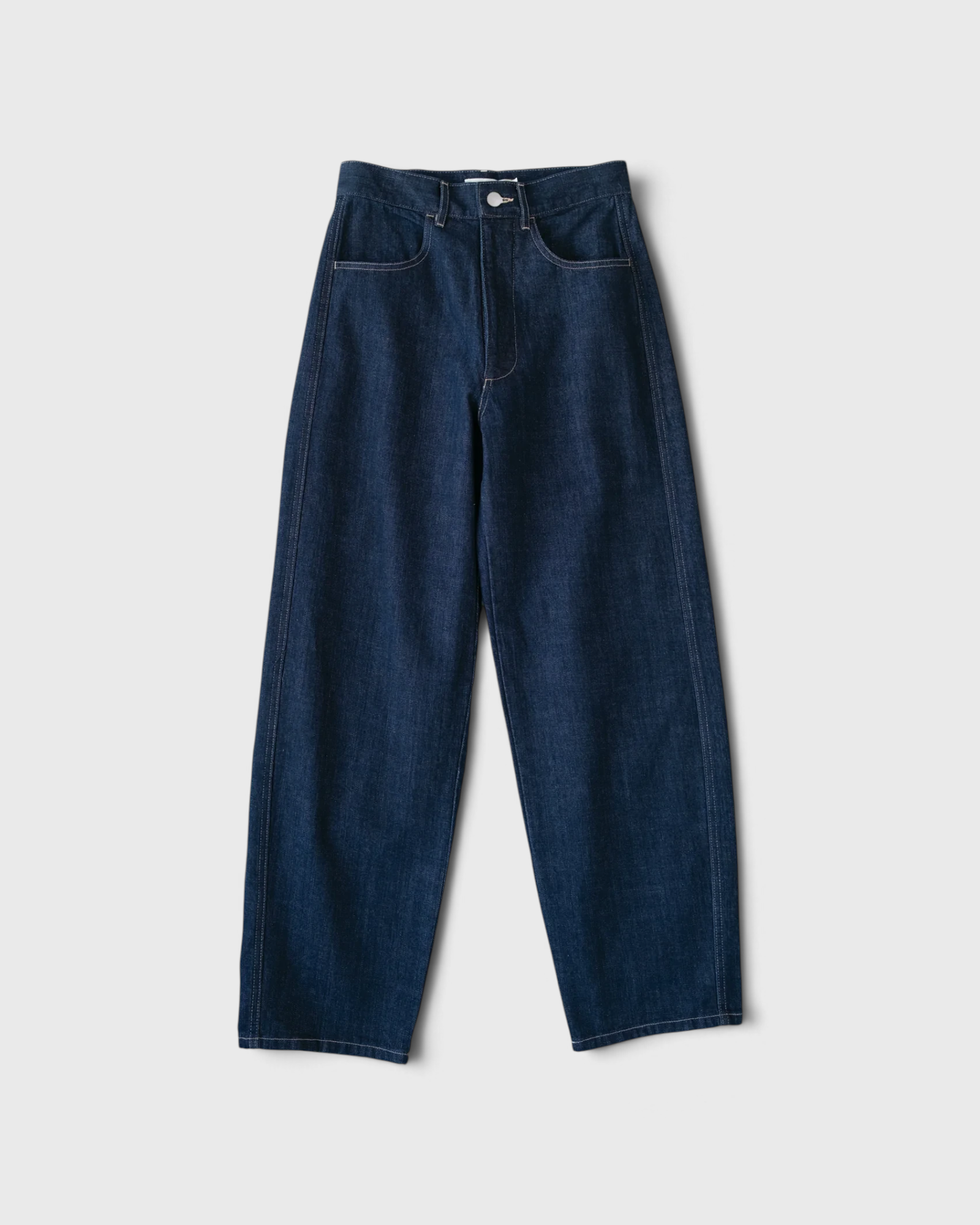 JONES + CO dark indigo high-rise relaxed-fit jeans with outseam piecing and a rounded leg silhouette.