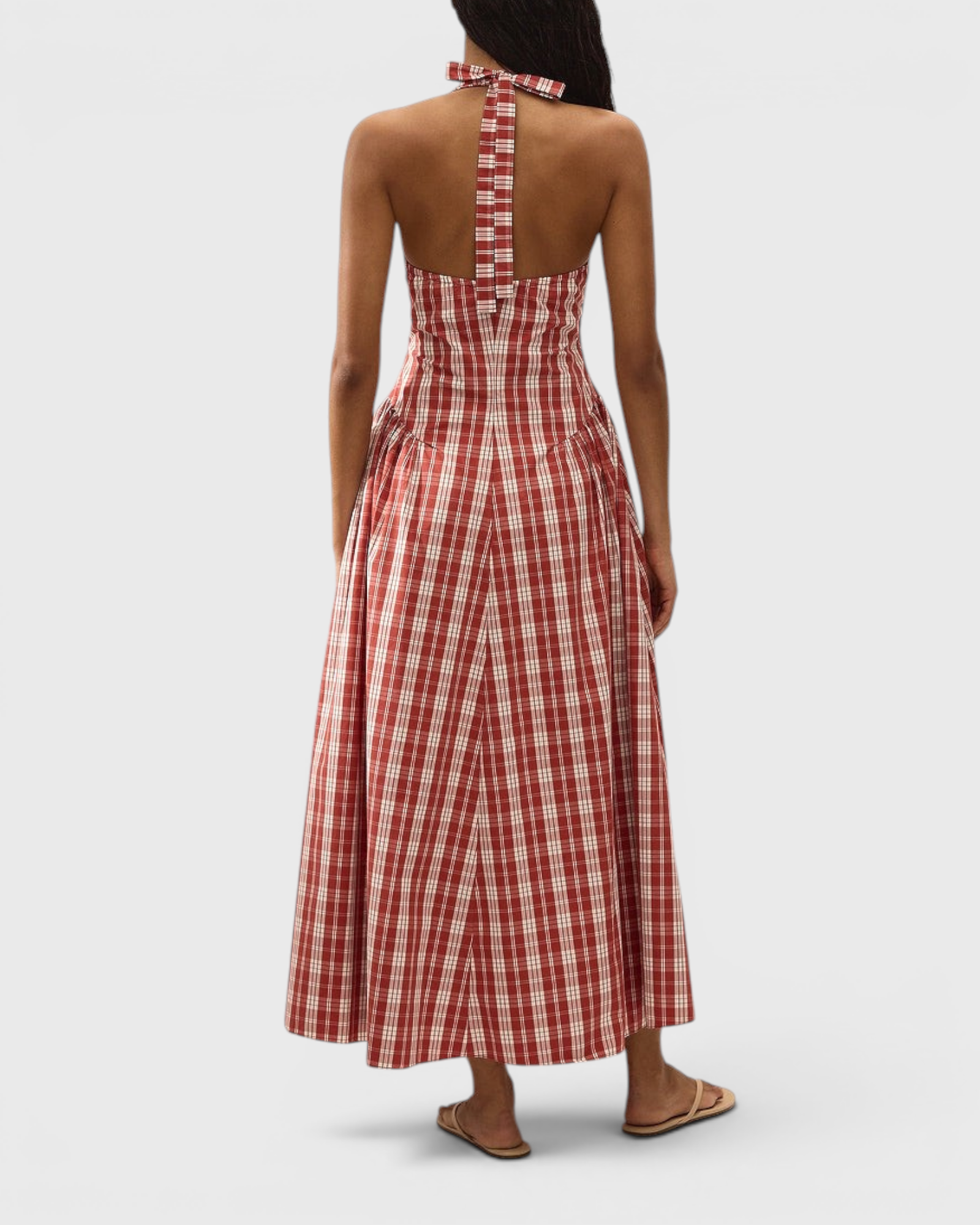 JONES + CO Del Rose midi dress in terra rosso check cotton with a halterneck and open back, worn by a model.