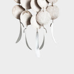 JONES + CO Dreamweaver wall hanging in Full Moon White featuring stoneware discs and hemp rope accents.