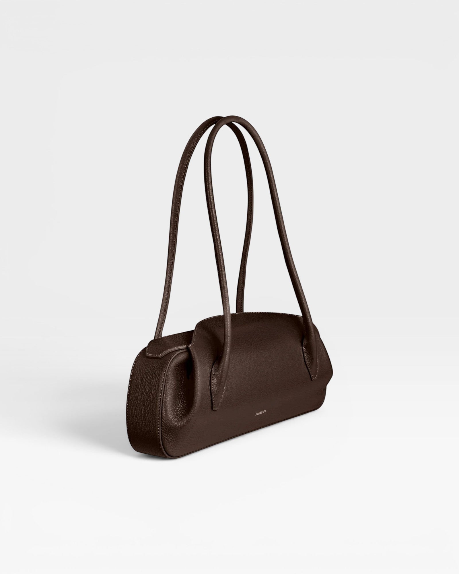 JONES + CO Oyster shoulder bag in espresso brown pebbled leather with long slender straps and a structured silhouette.