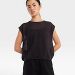 JONES + CO faded black boxy tank top in an airy fine mesh stitch with refined trim details worn by a model