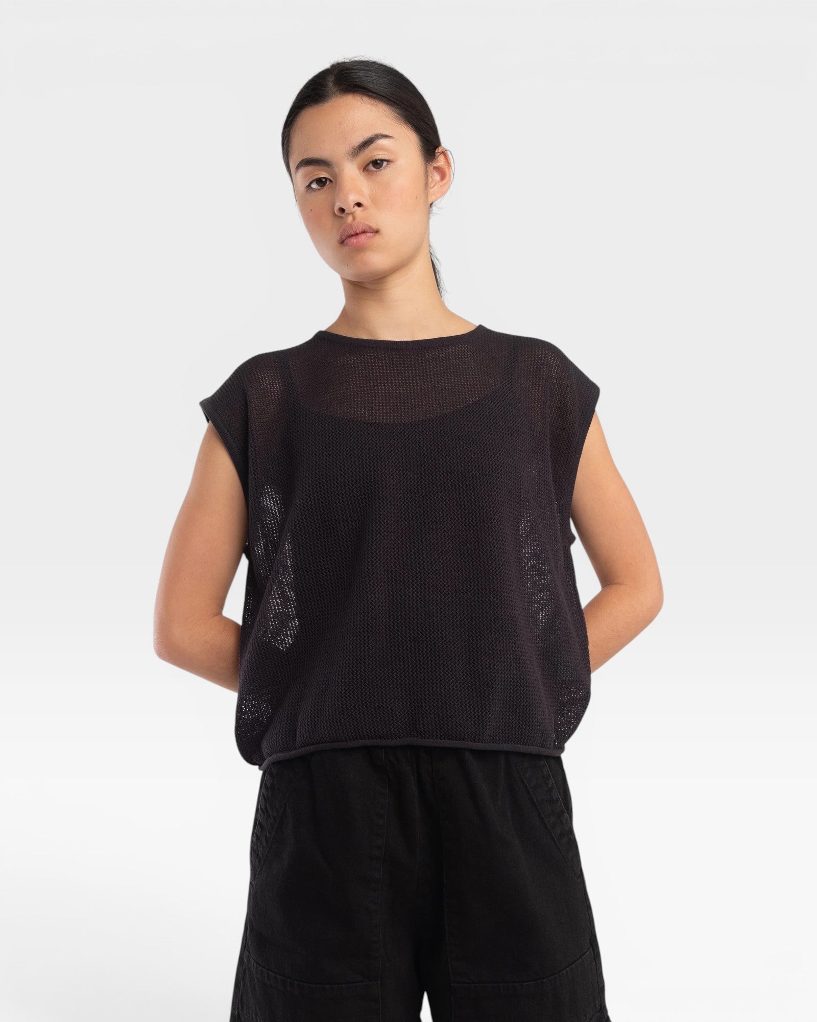 JONES + CO faded black boxy tank top in an airy fine mesh stitch with refined trim details worn by a model