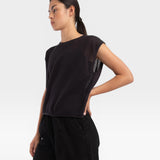 JONES + CO faded black boxy tank top in an airy fine mesh stitch with refined trim details worn by a model.