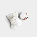 JONES + CO Flower Temple shower steamer with dried floral petals in white paper packaging on a neutral background.