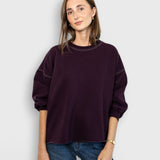 JONES + CO Rachel Comey Fond sweatshirt in plum with drop shoulders, cropped sleeves, and raw edge hemline.
