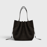 JONES + CO Scallop Tote in rich ganache brown suede with a gathered drawstring design and slim shoulder straps.