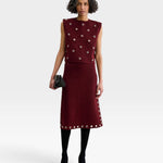 JONES + CO garnet baby alpaca knit vest with metallic eyelet details worn with a matching midi skirt