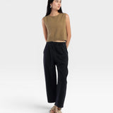 JONES + CO ginger boucle crop tank with hand crochet edge detail worn by a model with black pants and sandals