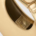 JONES + CO Good Night Moon evening bag in polished gold leather with a crescent silhouette and detachable strap