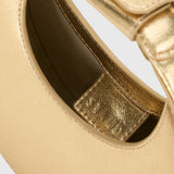 JONES + CO Good Night Moon evening bag in polished gold leather with a crescent silhouette and detachable strap