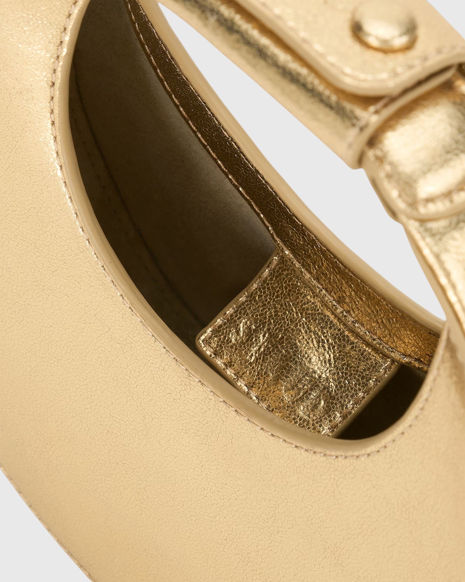 JONES + CO Good Night Moon evening bag in polished gold leather with a crescent silhouette and detachable strap