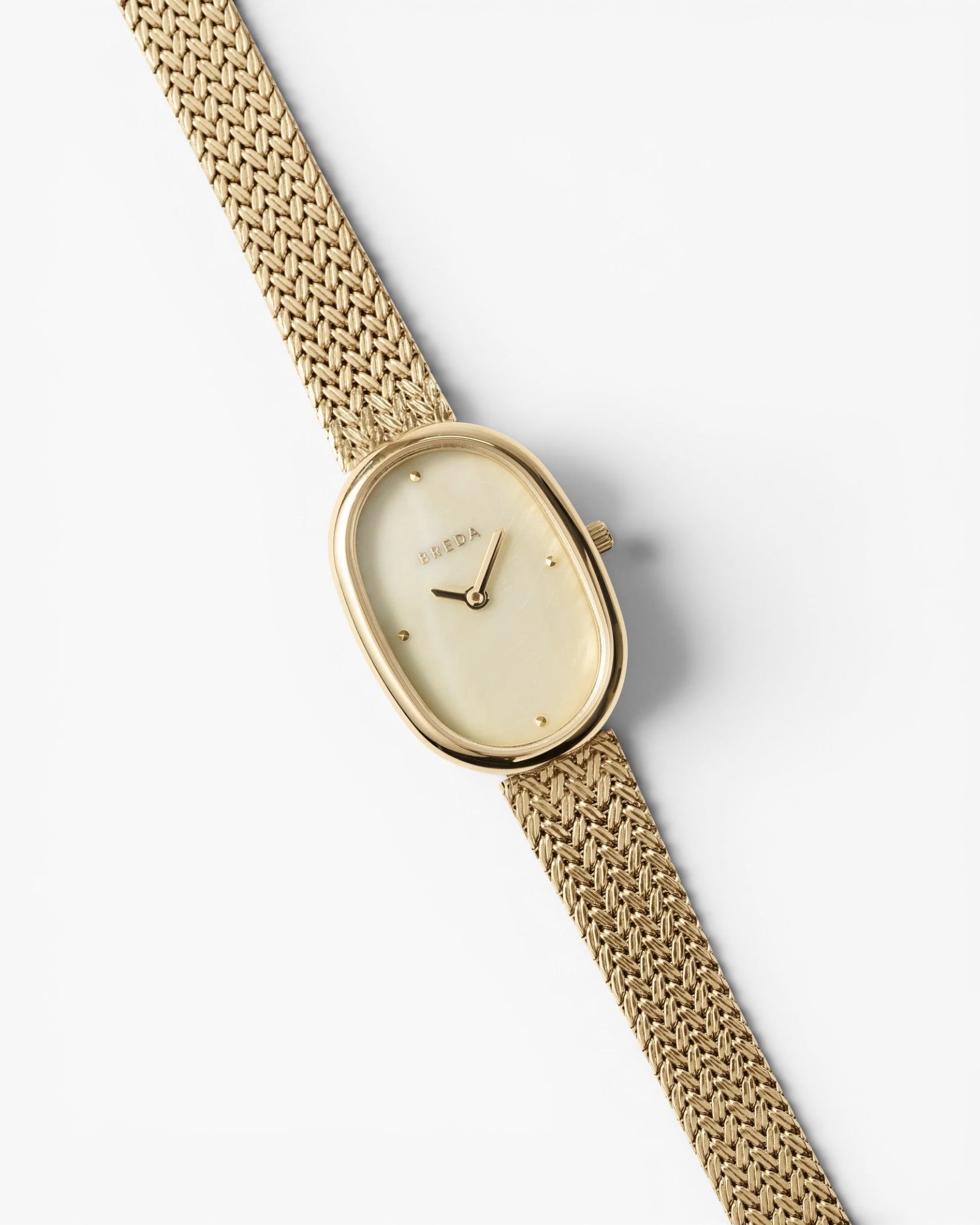 JONES + CO Jane Tethered watch with a gold oval case, champagne mother-of-pearl dial, and woven mesh bracelet.