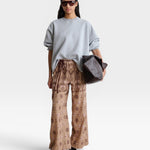JONES + CO model wearing a grey Rachel Comey Fond crewneck sweatshirt with drop shoulders and raw edge hem