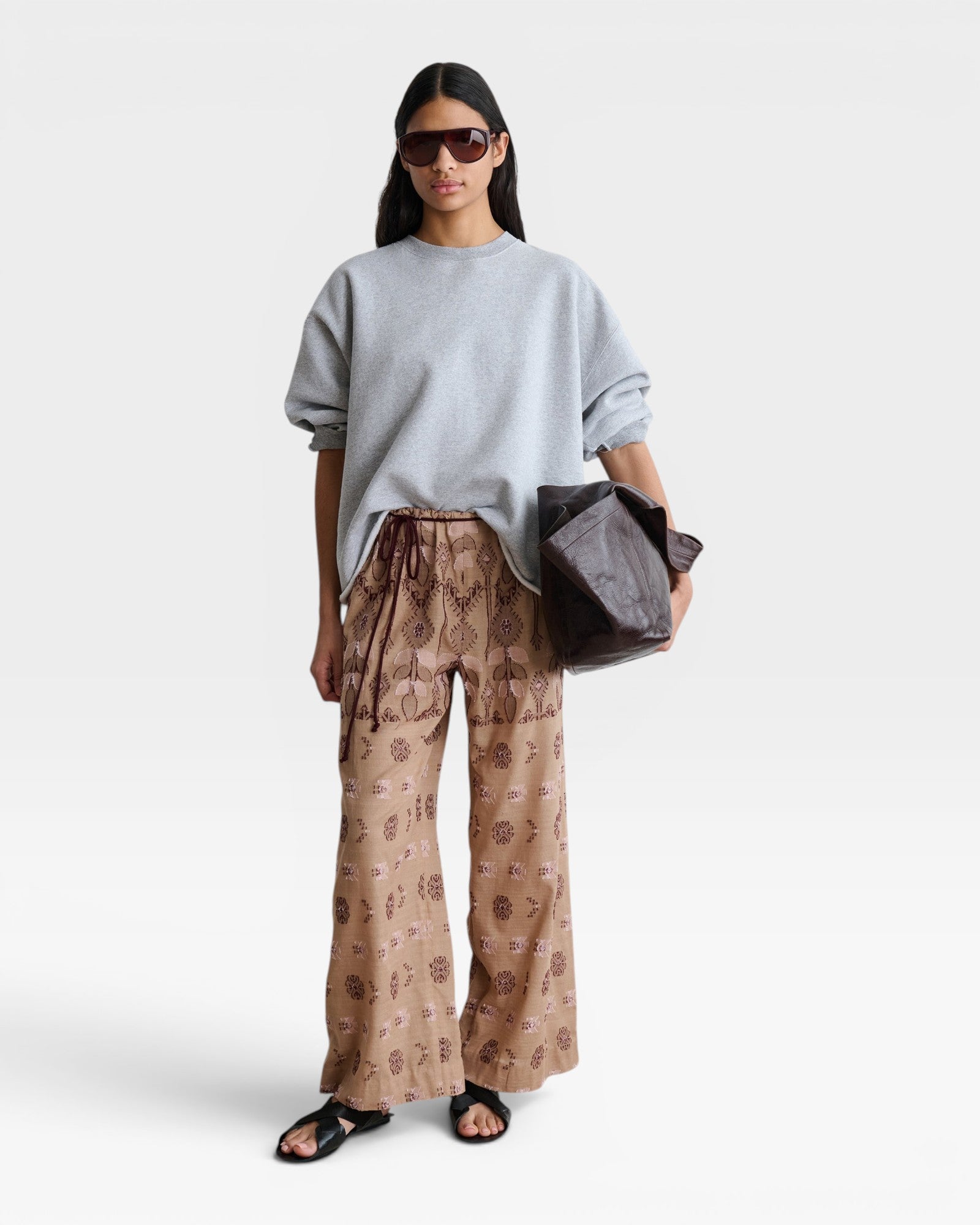 JONES + CO model wearing a grey Rachel Comey Fond crewneck sweatshirt with drop shoulders and raw edge hem