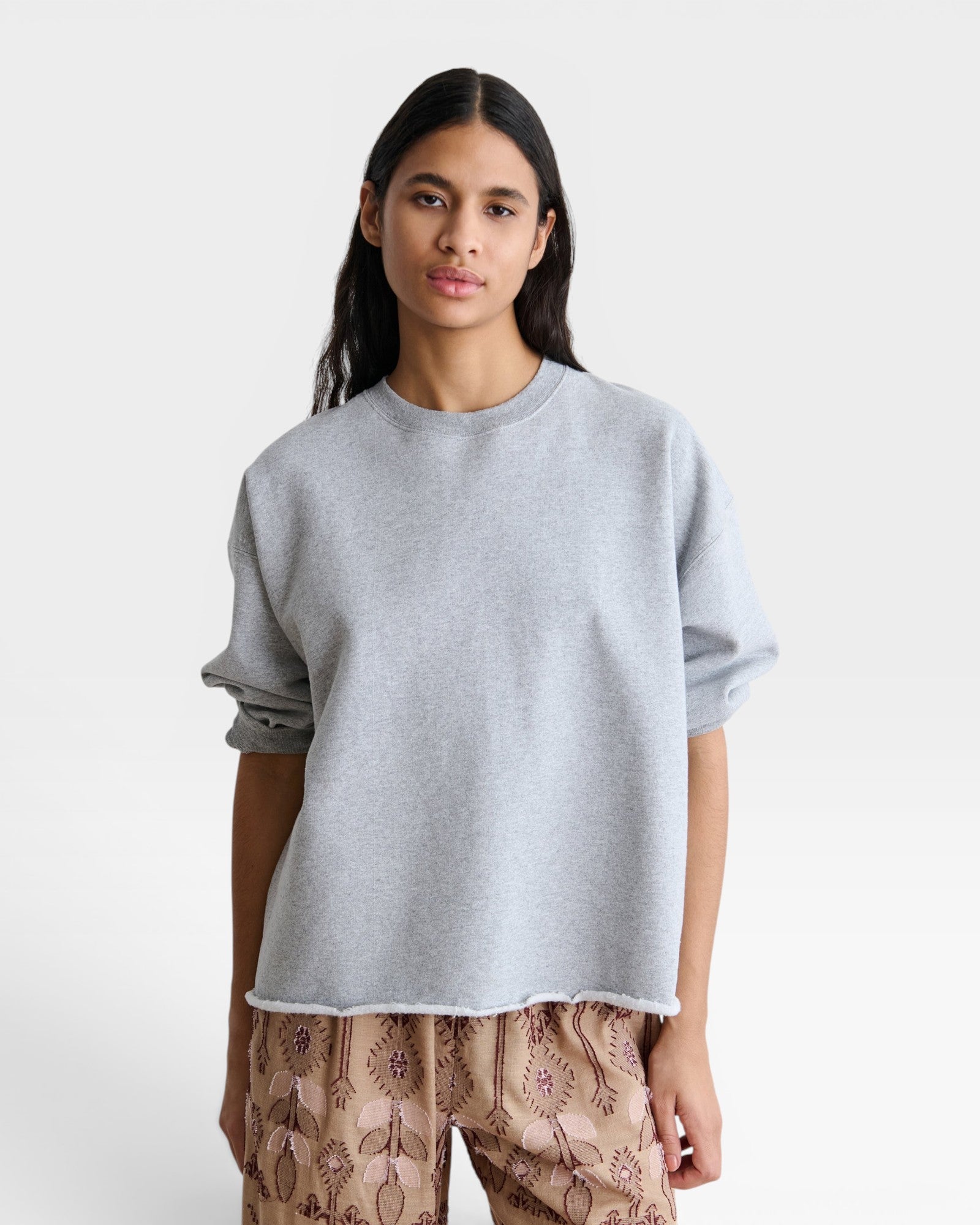 JONES + CO Rachel Comey grey crewneck sweatshirt with drop shoulders, cropped sleeves, and a raw edge hemline.