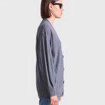 JONES + CO grey lightweight tissue cardigan with side button cinch detail worn by a model in profile view