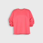 JONES + CO Fond crewneck sweatshirt in guava pink featuring drop shoulders, cropped sleeves, and raw edge hemline.