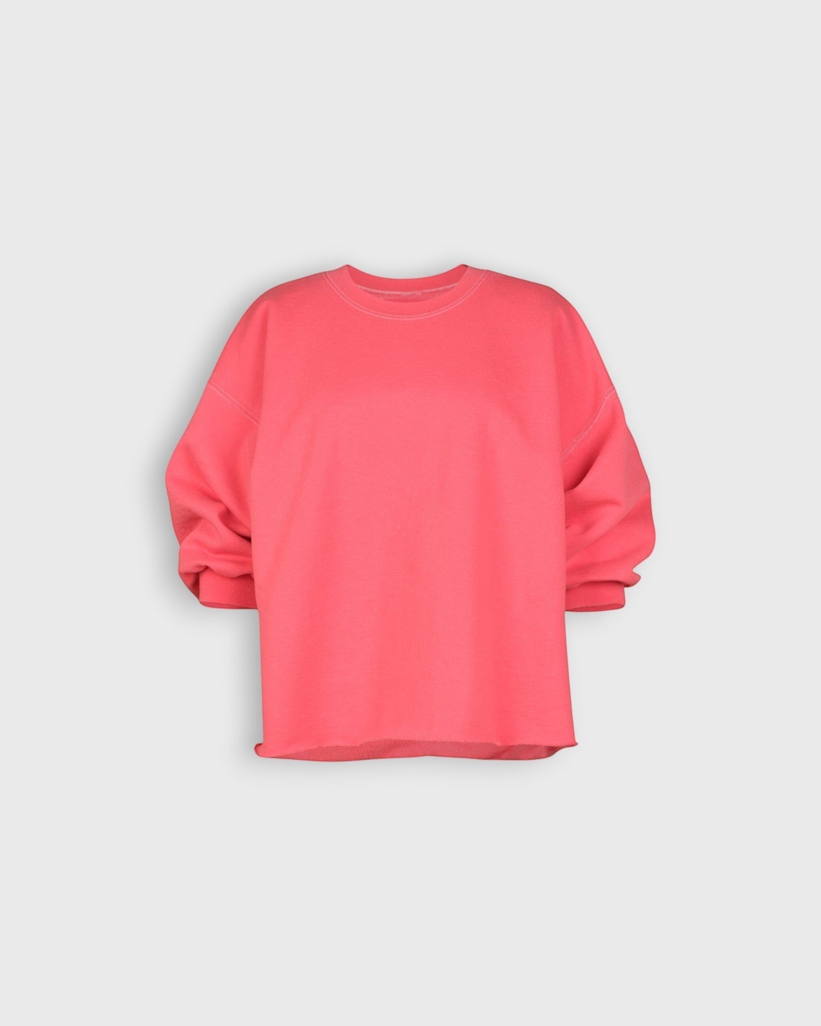 JONES + CO Fond crewneck sweatshirt in guava pink featuring drop shoulders, cropped sleeves, and raw edge hemline.