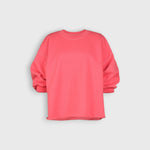 JONES + CO Fond crewneck sweatshirt in guava pink featuring drop shoulders, cropped sleeves, and raw edge hemline.