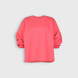 JONES + CO Fond crewneck sweatshirt in guava pink featuring drop shoulders, cropped sleeves, and raw edge hemline.