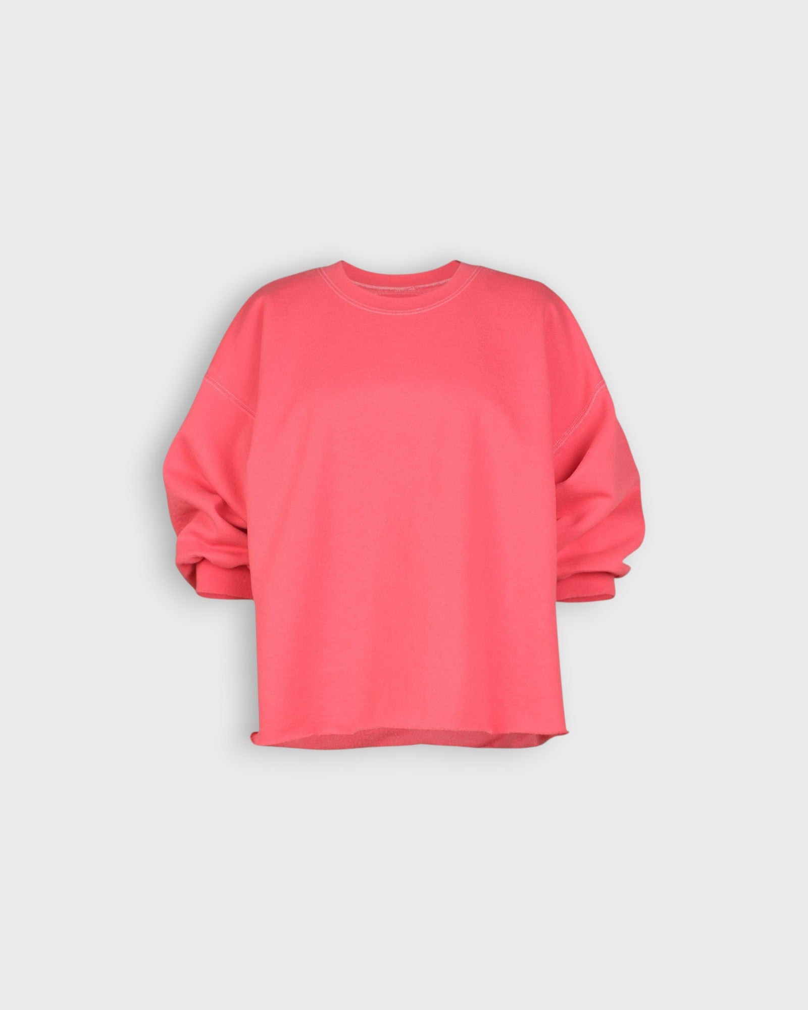 JONES + CO Fond crewneck sweatshirt in guava pink featuring drop shoulders, cropped sleeves, and raw edge hemline.