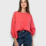 JONES + CO Fond crewneck sweatshirt in guava pink with drop shoulders, cropped sleeves, and raw edge hemline.