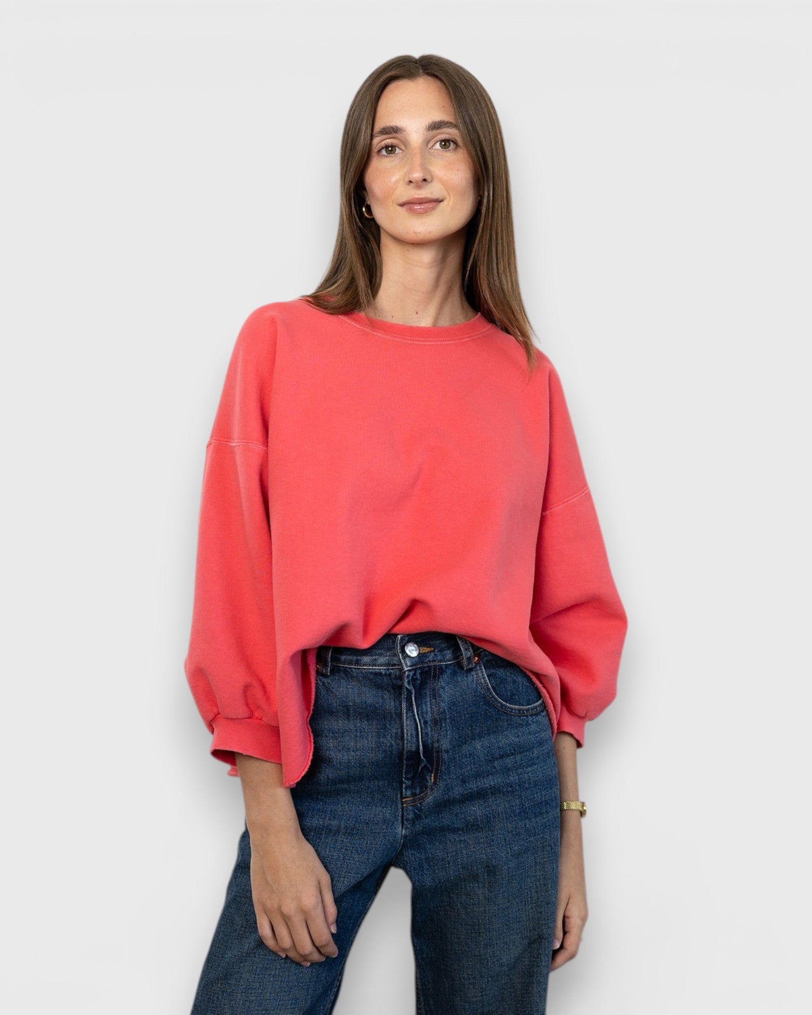 JONES + CO Fond crewneck sweatshirt in guava pink with drop shoulders, cropped sleeves, and raw edge hemline.