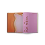 JONES + CO Live Your Vision journal open to the Putting It Into Action section with pink and orange abstract pages.