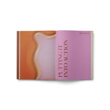 JONES + CO Live Your Vision journal open to the Putting It Into Action section with pink and orange abstract pages.