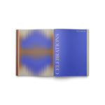 JONES + CO Live Your Vision journal open to the blue Celebrations section with abstract gradient design