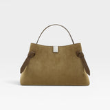JONES + CO Gyoza pouch in fennel suede with a top handle, brown leather accents, and a silver metal clasp.