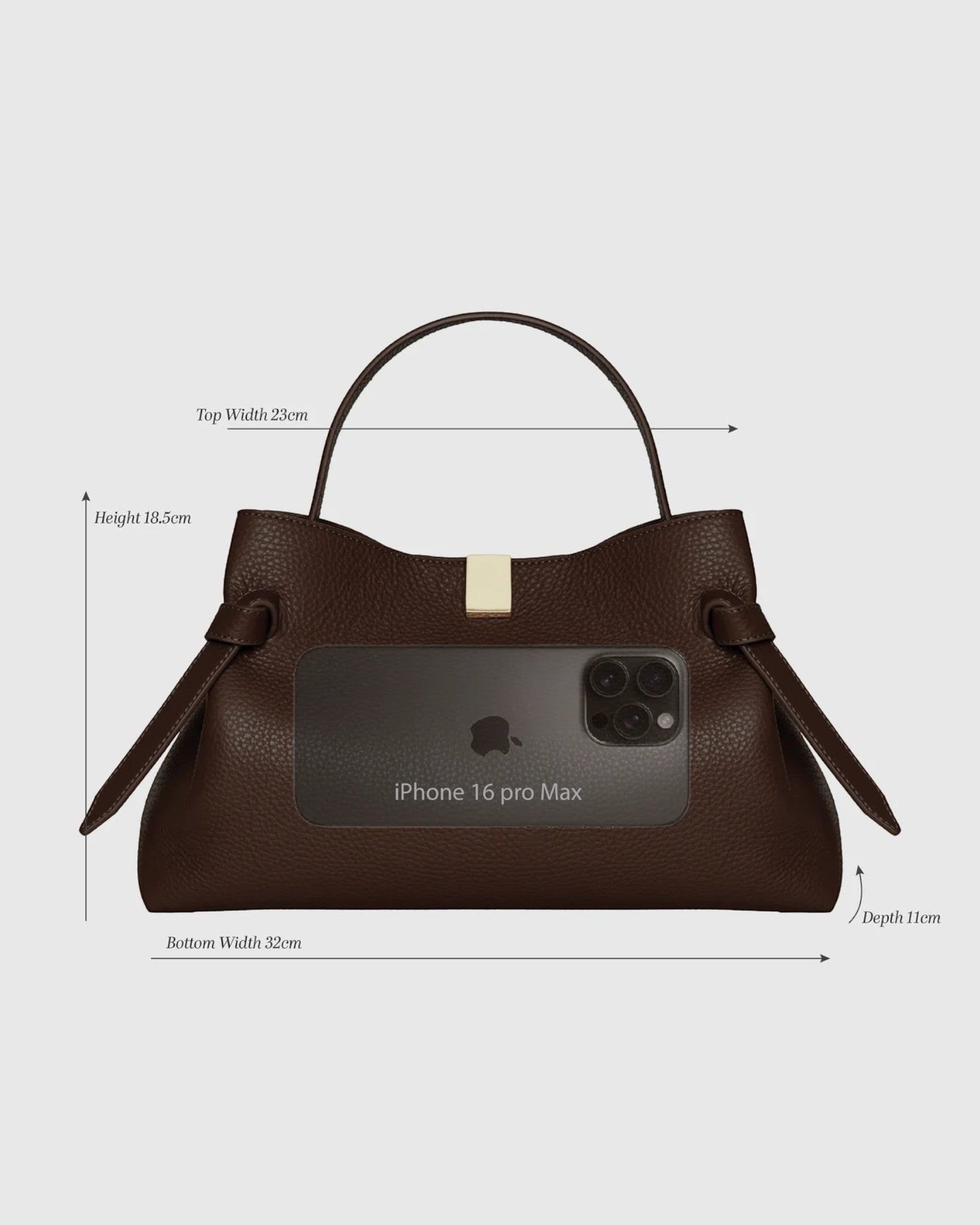 JONES + CO Gyoza pouch in fennel brown suede with a top handle, gold hardware, and size reference to an iPhone 16.