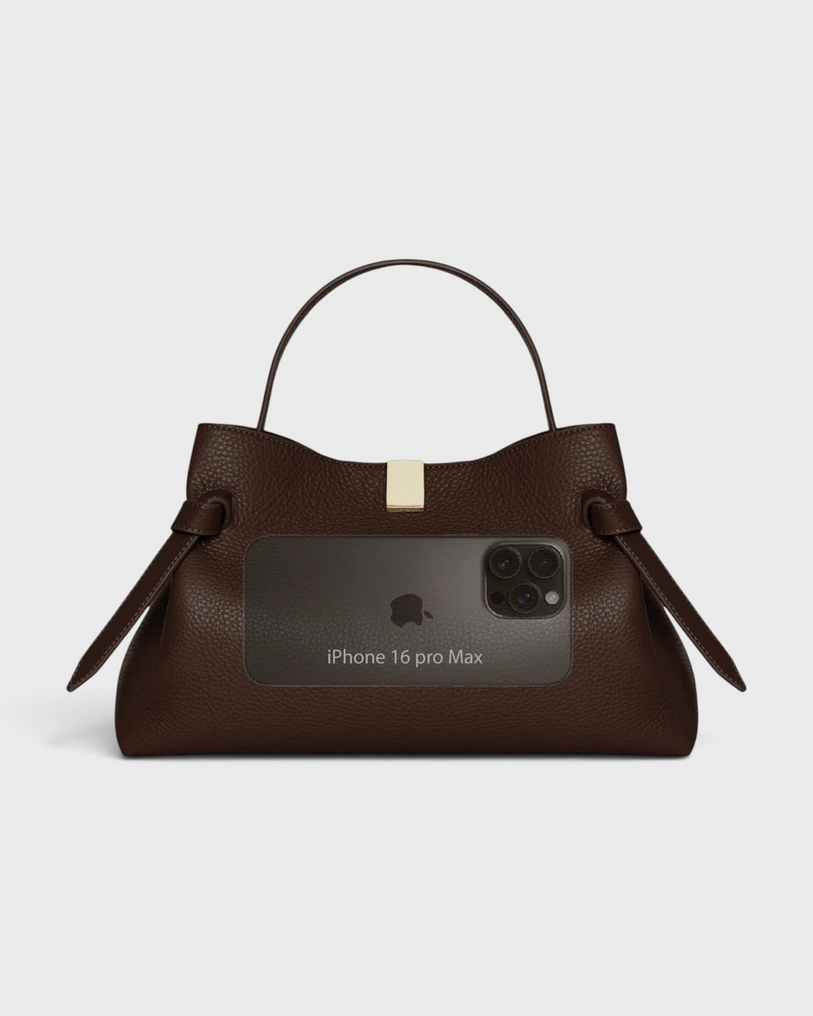 JONES + CO Gyoza pouch in fennel brown suede with a top handle, gold hardware, and size reference to an iPhone 16.