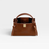 JONES + CO Gyoza Mini handbag in sierra brown embossed Italian leather with gold-tone hardware and top handle.