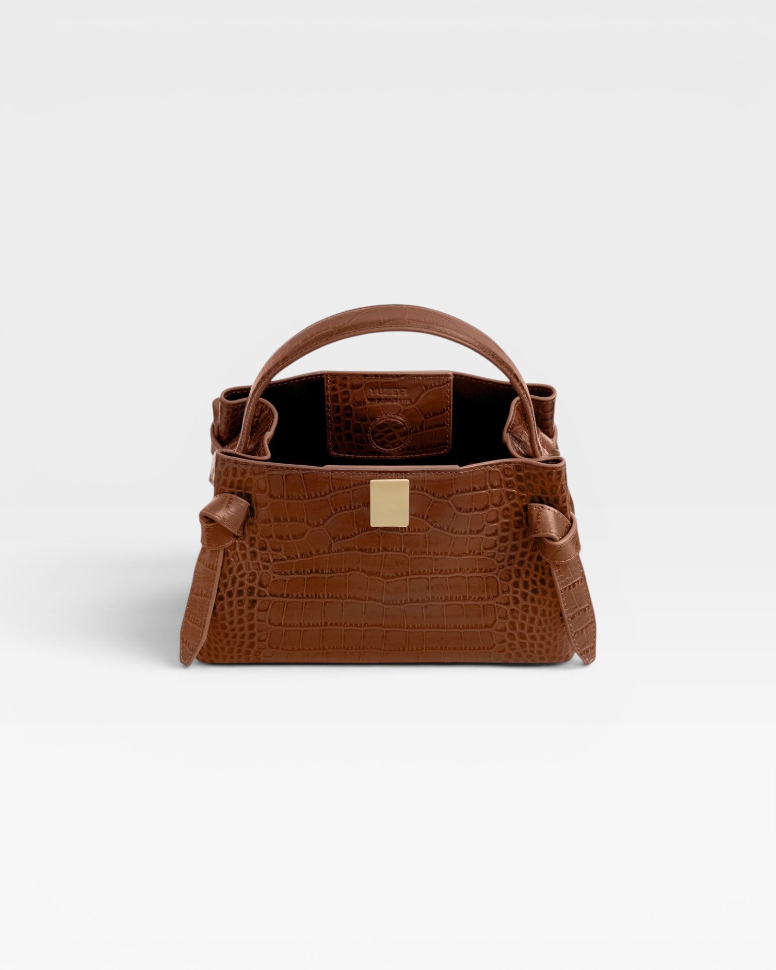 JONES + CO Gyoza Mini handbag in sierra brown embossed Italian leather with gold-tone hardware and top handle.