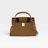 JONES + CO Gyoza Mini handbag in cognac suede with a sculptural top handle and elegant gold-tone hardware.