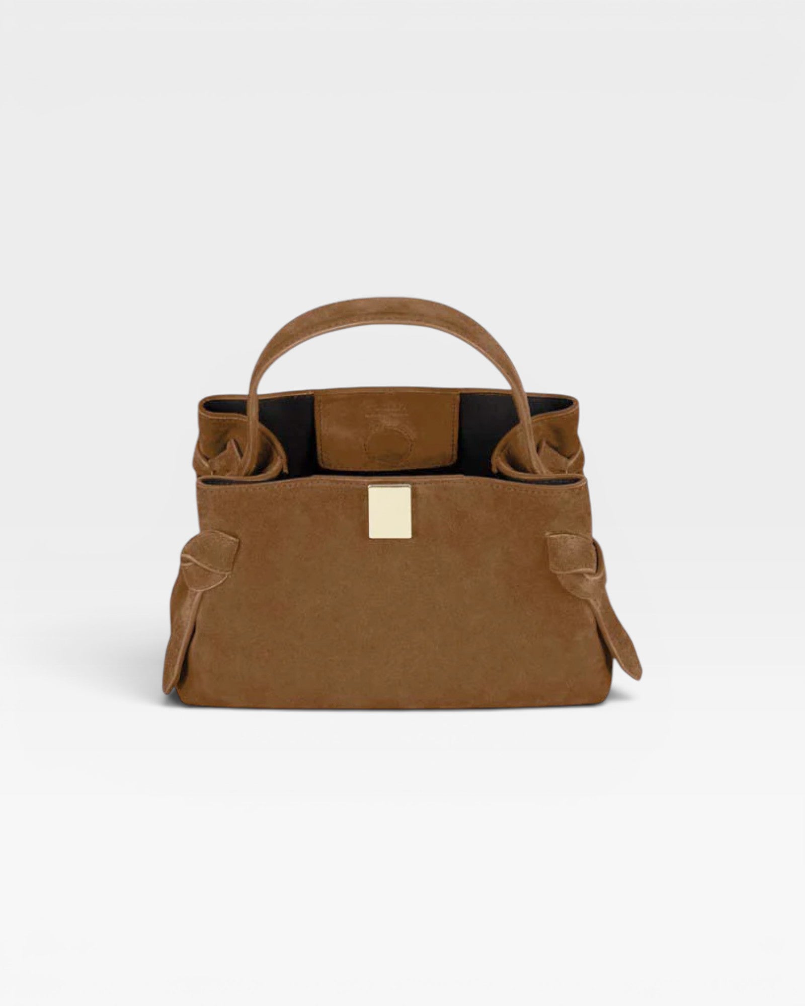 JONES + CO Gyoza Mini handbag in cognac suede with a sculptural top handle and elegant gold-tone hardware.