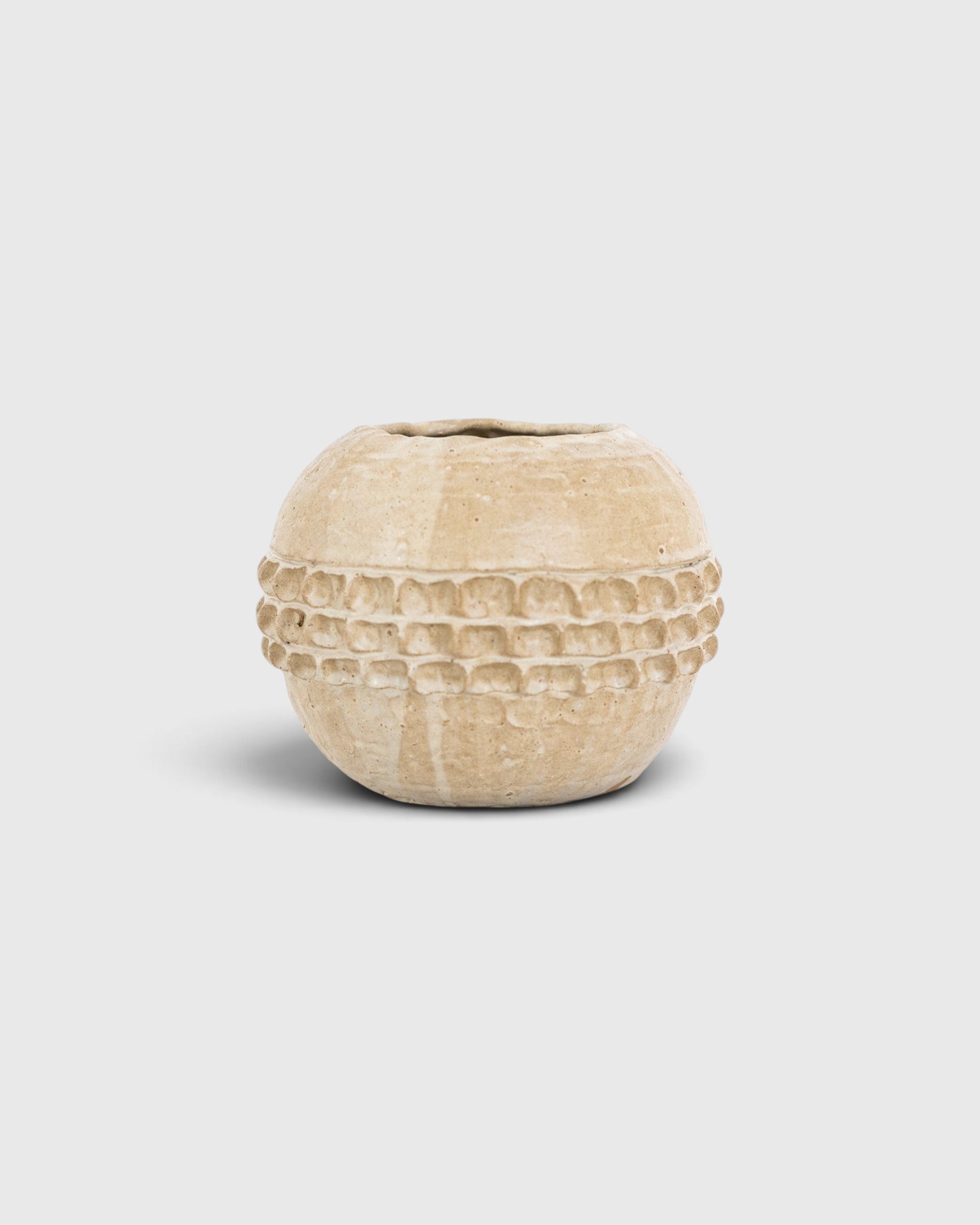 JONES + CO handthrown ceramic Vase No. 3 in a beige glaze with a textured, embossed band around the center.