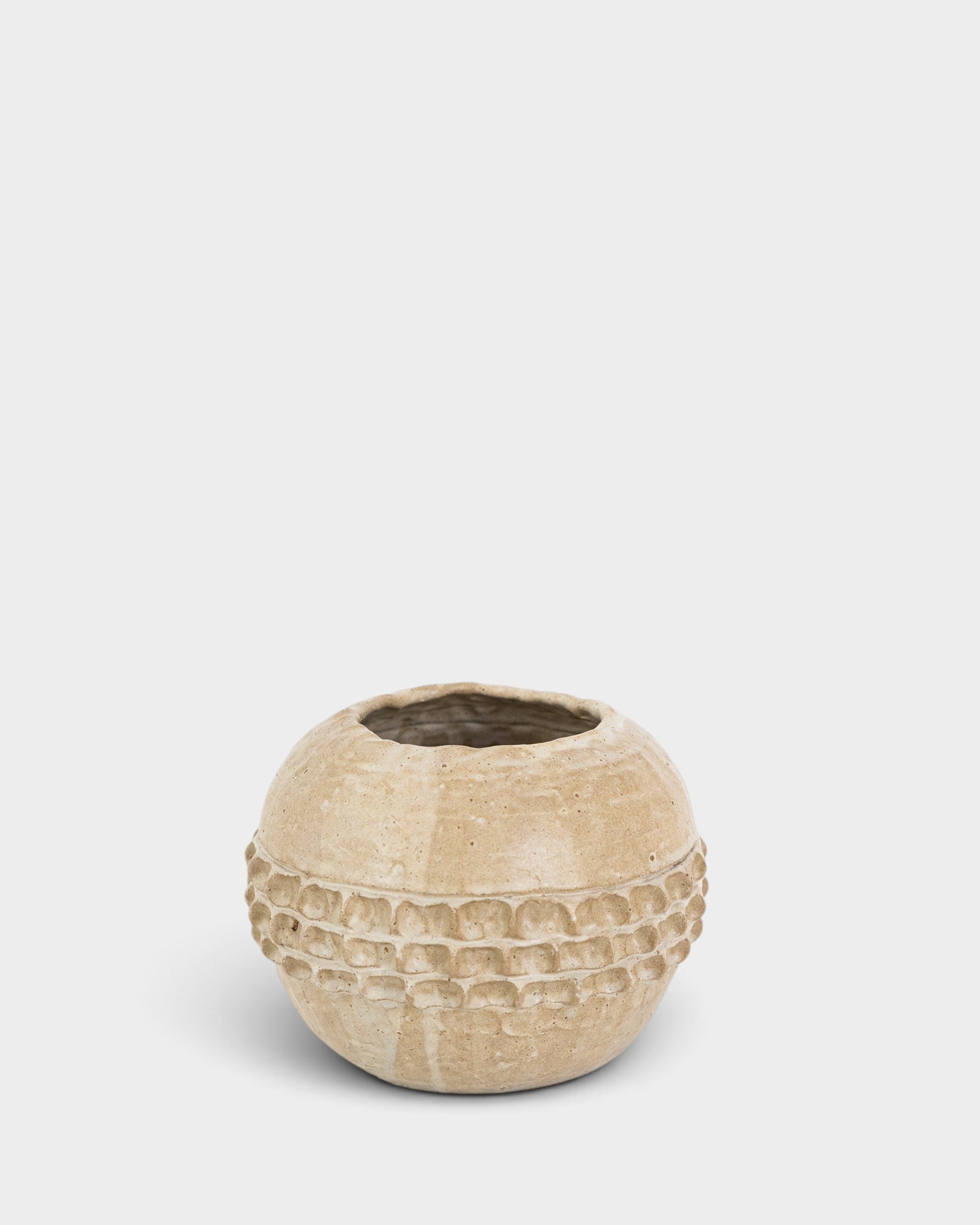 JONES + CO handthrown ceramic vase in a neutral beige tone with a textured, dimpled band around the center.