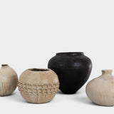 JONES + CO collection of four unique handthrown ceramic vases in neutral beige and matte black tones.