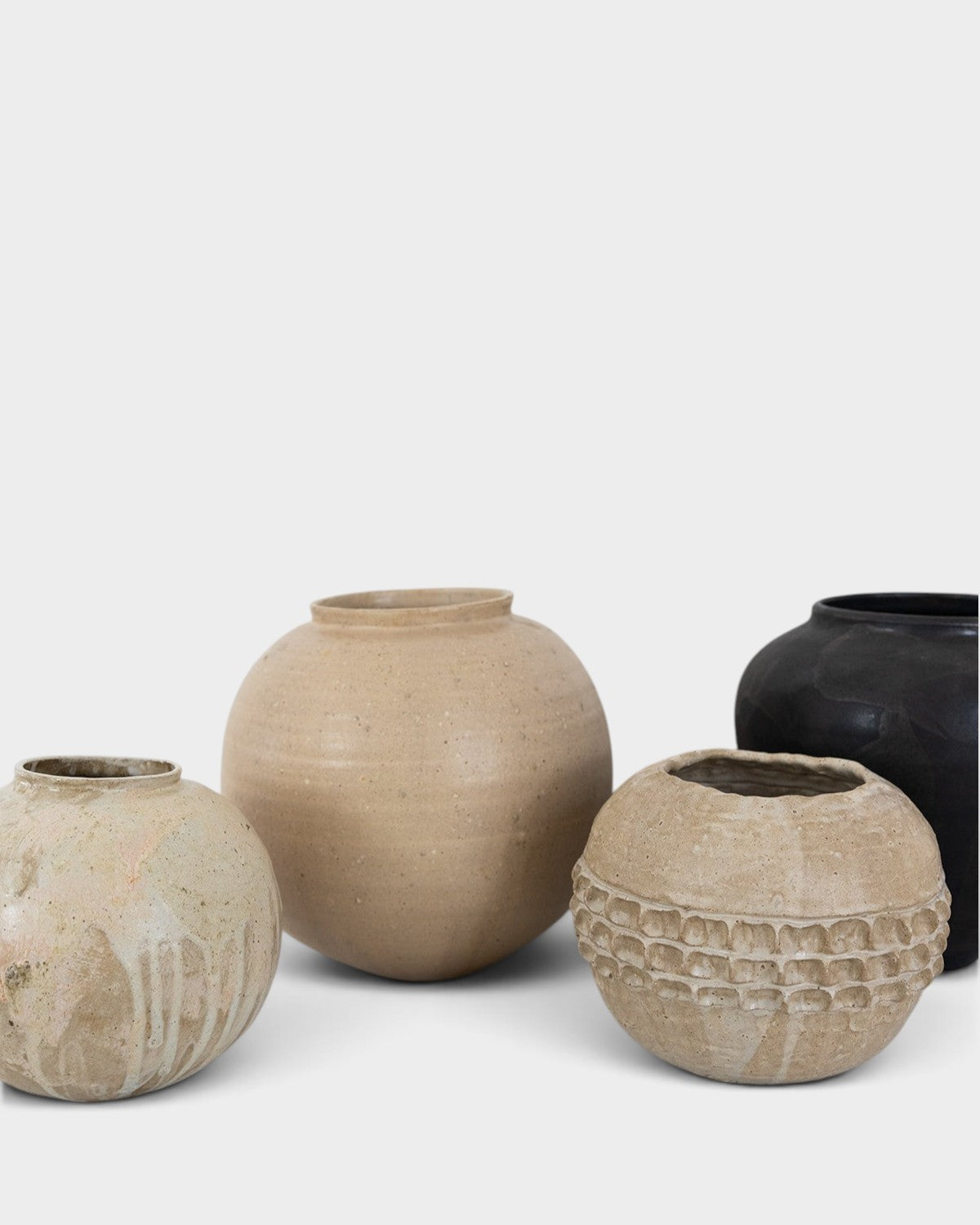 JONES + CO handthrown ceramic vases in neutral beige and black tones with textured and smooth finishes