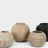 JONES + CO handthrown ceramic vases in neutral and black tones with textured, organic, and sculptural designs.