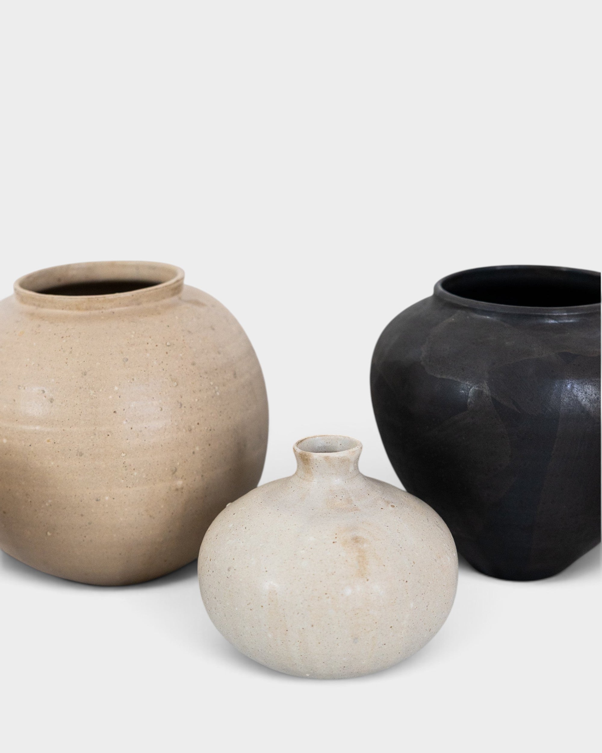 JONES + CO handthrown ceramic vases in beige, cream, and matte black with unique organic shapes