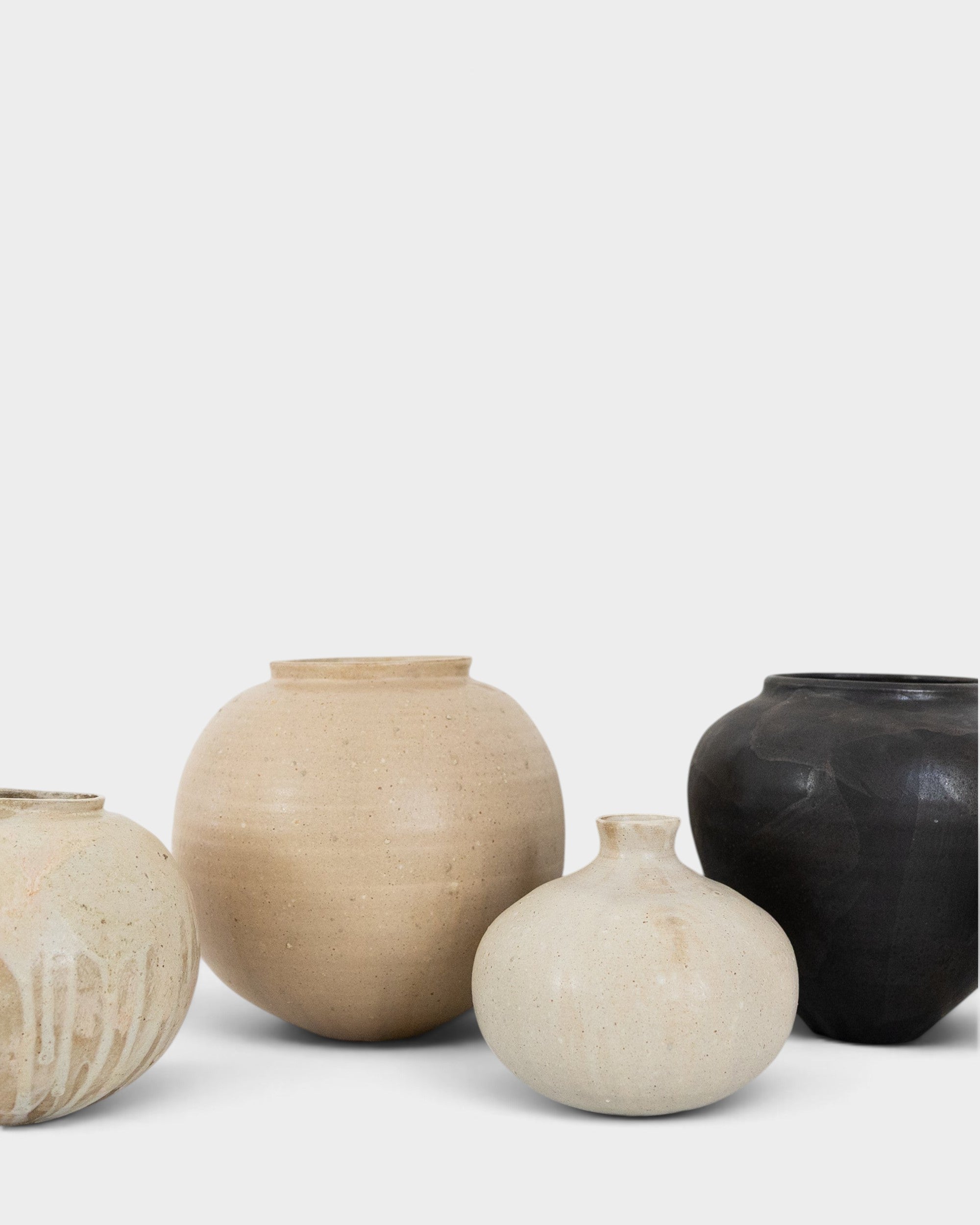 JONES + CO handthrown ceramic vases in various neutral and black tones with unique sculptural shapes