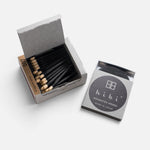 JONES + CO Hibi Japanese Wisteria incense matches in a grey box with black matchsticks and a striking surface.