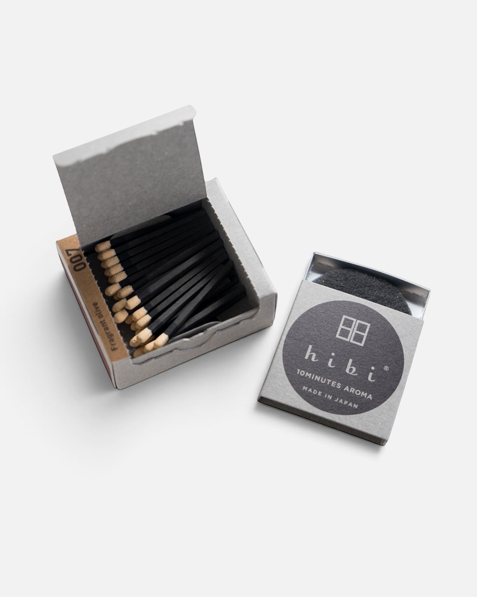JONES + CO Hibi Japanese Wisteria incense matches in a grey box with black matchsticks and a striking surface.