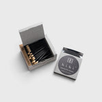 JONES + CO Hibi Ylang Ylang incense matches in a grey box with black matchsticks for a ten-minute aromatic experience.