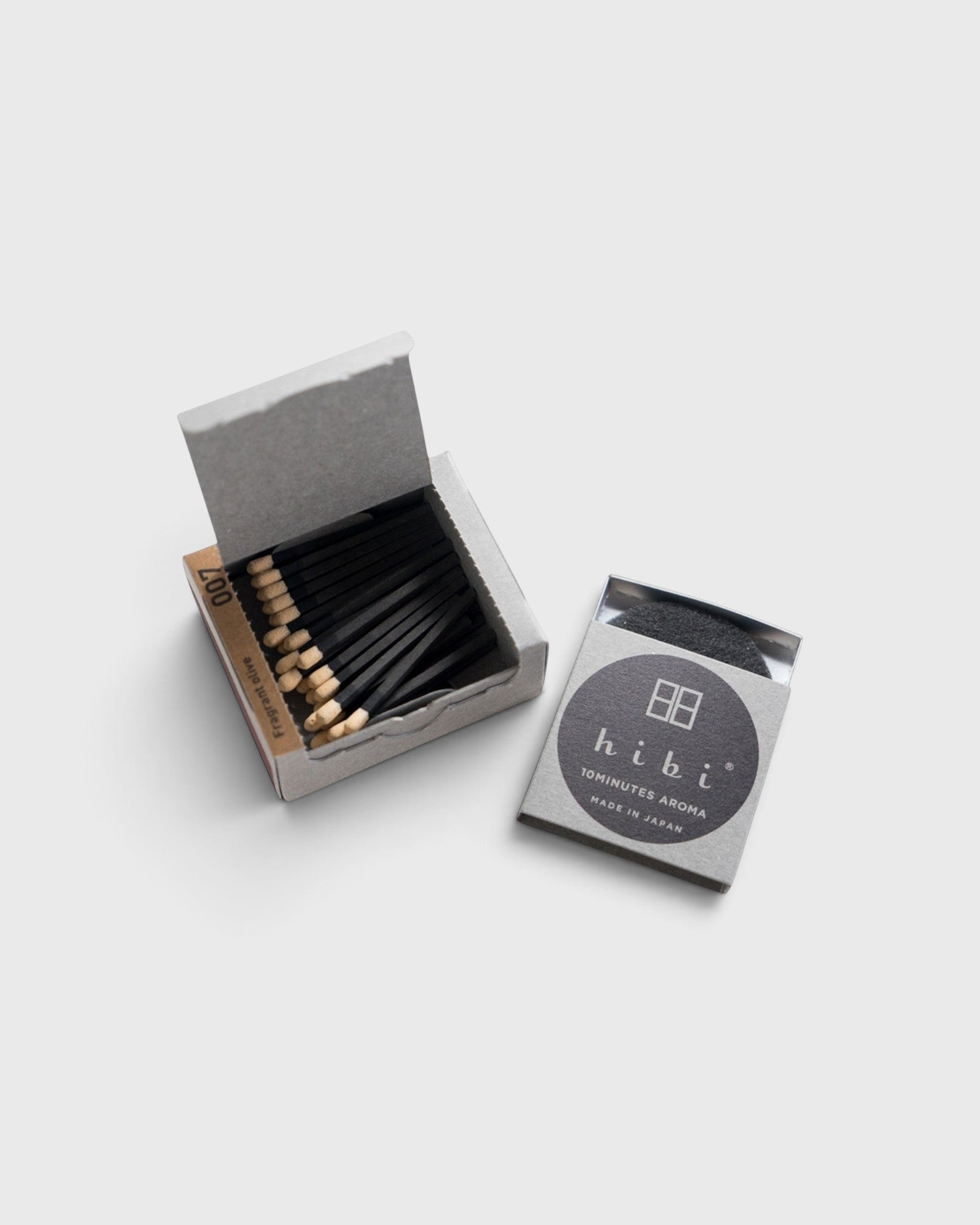 JONES + CO Hibi Ylang Ylang incense matches in a grey box with black matchsticks for a ten-minute aromatic experience.